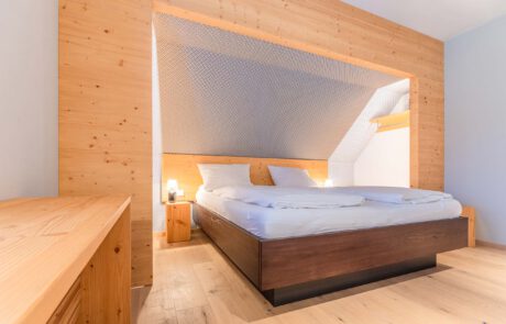 Bett individuell aus Holz nach Maß mit schöner Maserung und natürlichem Aussehen Look n Feel mit dunklem Holz
