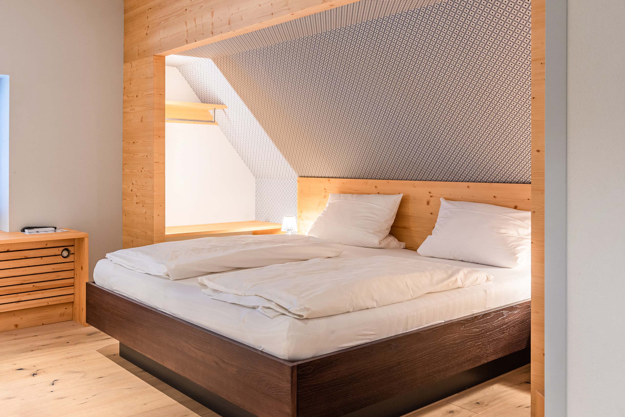 schickes Bett aus Holz nach Maß mit schöner Maserung und natürlichem Aussehen Look n Feel mit hellem Holz und schickem Muster auf der Tapete